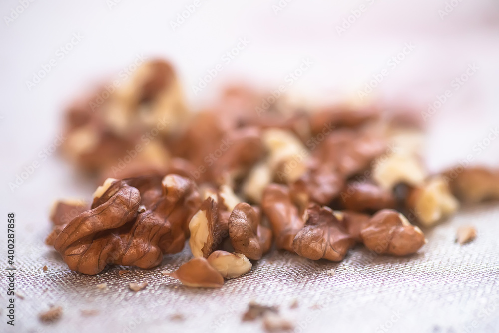 Obraz premium snouth of walnut kernels without peel is untreated on table. Ingredients for baking and pies.