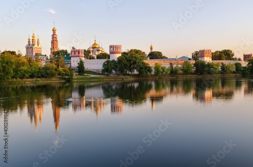 view of the novodevichy monastery in moscow on a summer evening from the opposite bank