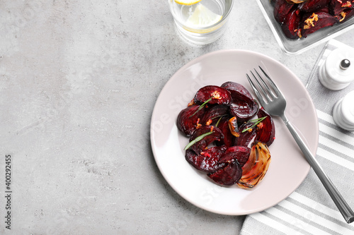 Roasted beetroot slices served on light grey table, flat lay. Space for text