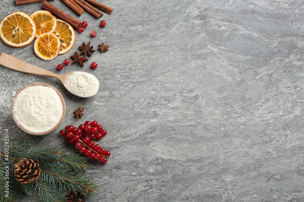 Flat lay composition with Christmas decor and flour on grey table. Space for text Flat lay composition with Christmas decor and flour on grey table. Space for text