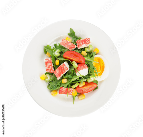 Plate with delicious crab stick salad isolated on white, top view