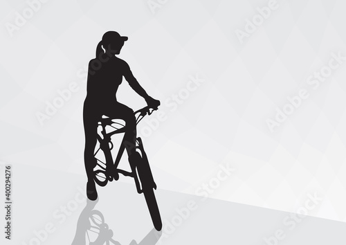 A girl on a bicycle stopped on the road after a long journey