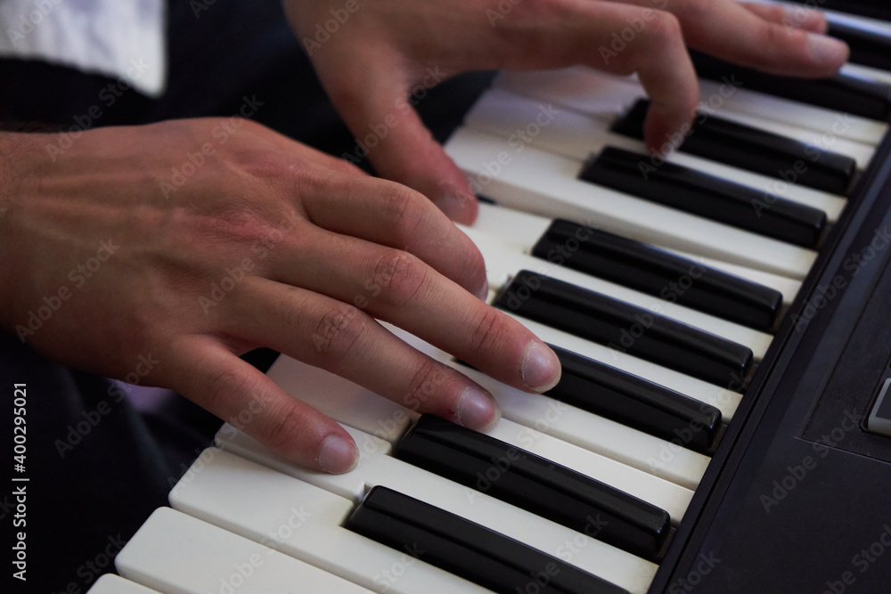 close-up detail of the hands of a pianist playing his instrument close-up detail of the hands of a pianist playing his instrument