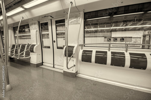 Photography Interior of subway train with empty seats.