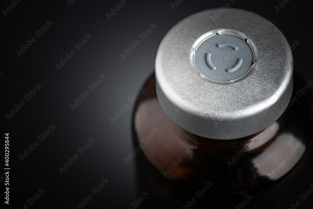 Macro Image Of Amber Vaccine Vial In Black Background Macro Image Of Amber Vaccine Vial In Black Background