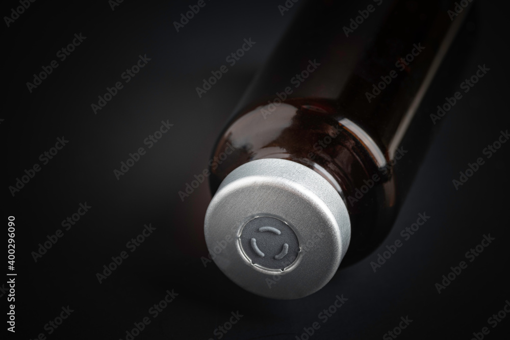 Macro Image Of Amber Vaccine Vial In Black Background Macro Image Of Amber Vaccine Vial In Black Background