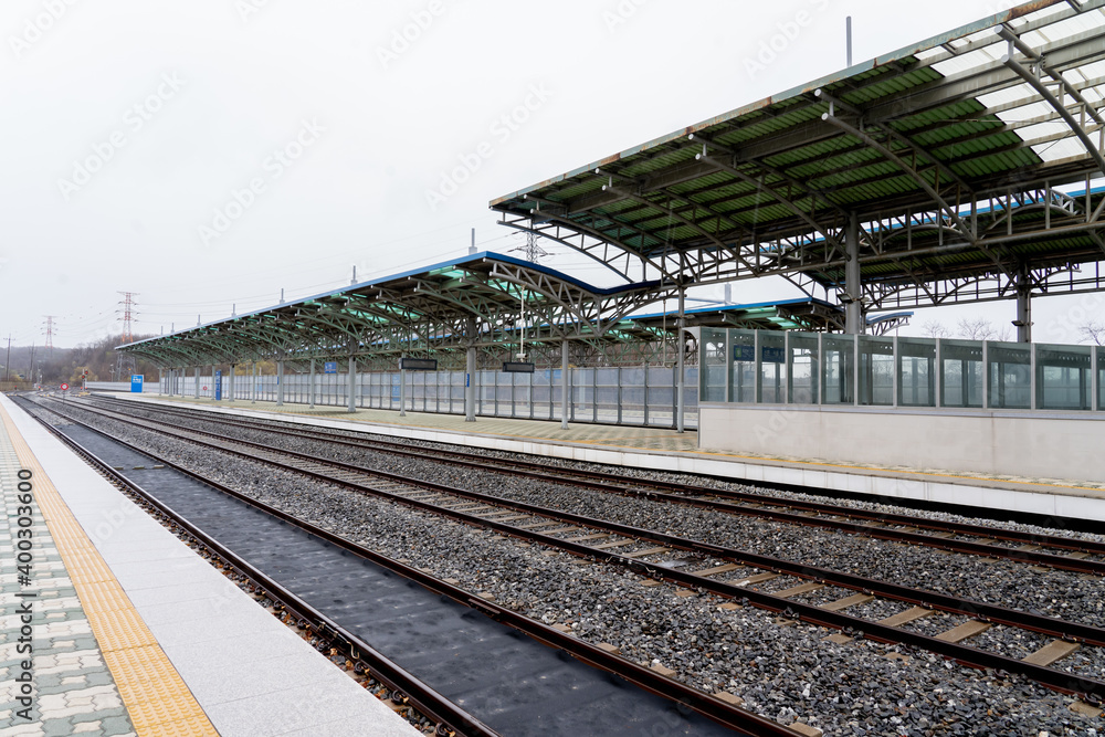 Paju, South Korean - April 10, 2019: Platform and railway tracks at Dorasan Station on the Gyeongui Line in Paju, South Korean, which used to connect North Korea and South Korea. Paju, South Korean - April 10, 2019: Platform and railway tracks at Dorasan Station on the Gyeongui Line in Paju, South Korean, which used to connect North Korea and South Korea.