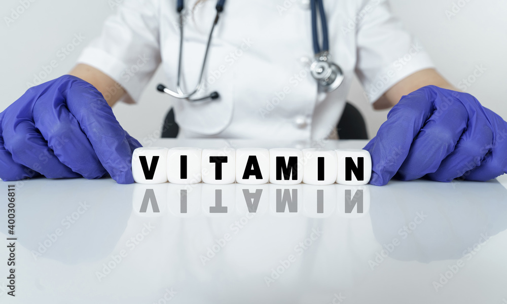 The doctor put together a word from cubes VITAMIN The doctor put together a word from cubes VITAMIN