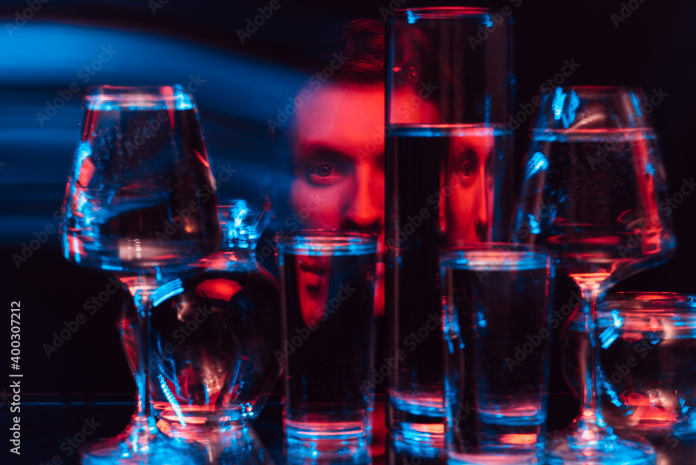 psychedelic surreal portrait of a man through glasses of water with blur psychedelic surreal portrait of a man through glasses of water with blur