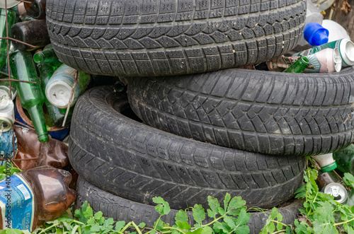 Used tires and bottles thrown away photo