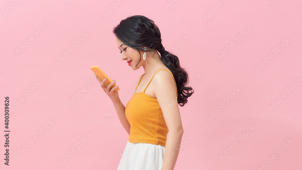 Young woman doctor holding her smartphone while smiling into the camera Young woman doctor holding her smartphone while smiling into the camera