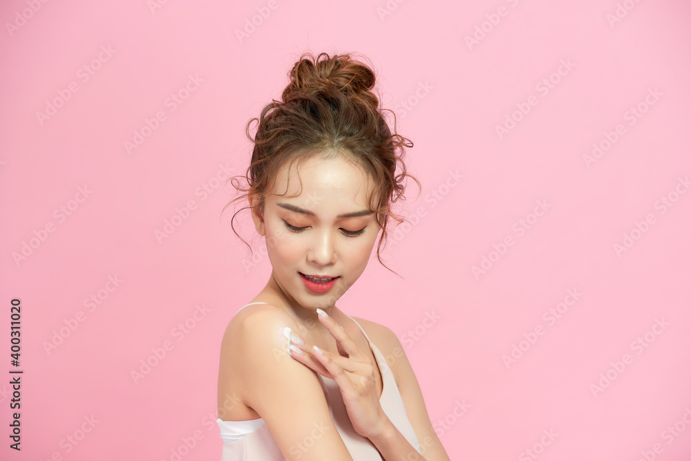 Young girl with hair fixed behind, clean fresh skin, big eyes and shoulders posing