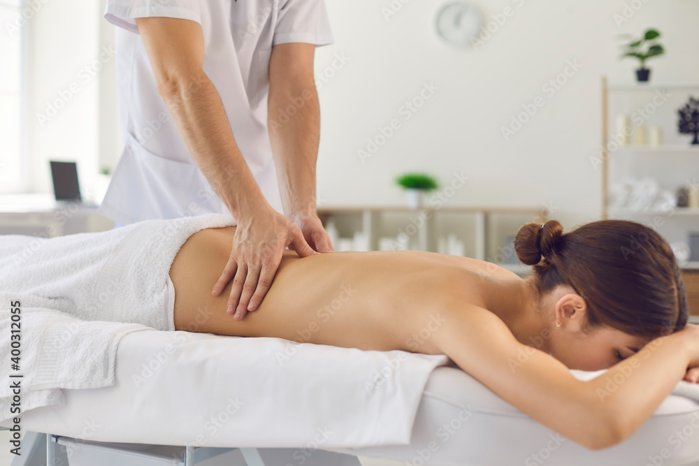 Fototapeta premium Professional doctor masseur during work with patient in medical clinic