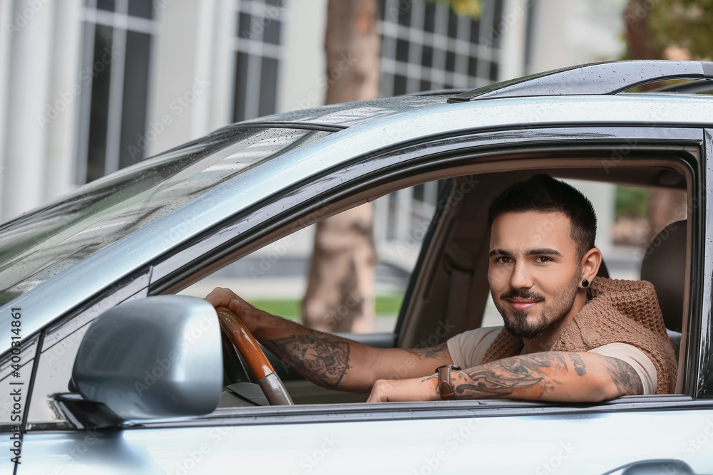 Naklejka premium Handsome man driving modern car