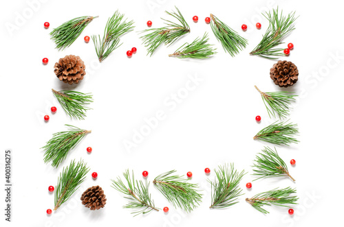 Christmas composition on a white background. Pine branches and cones. Flat lay, top view, copy space.
