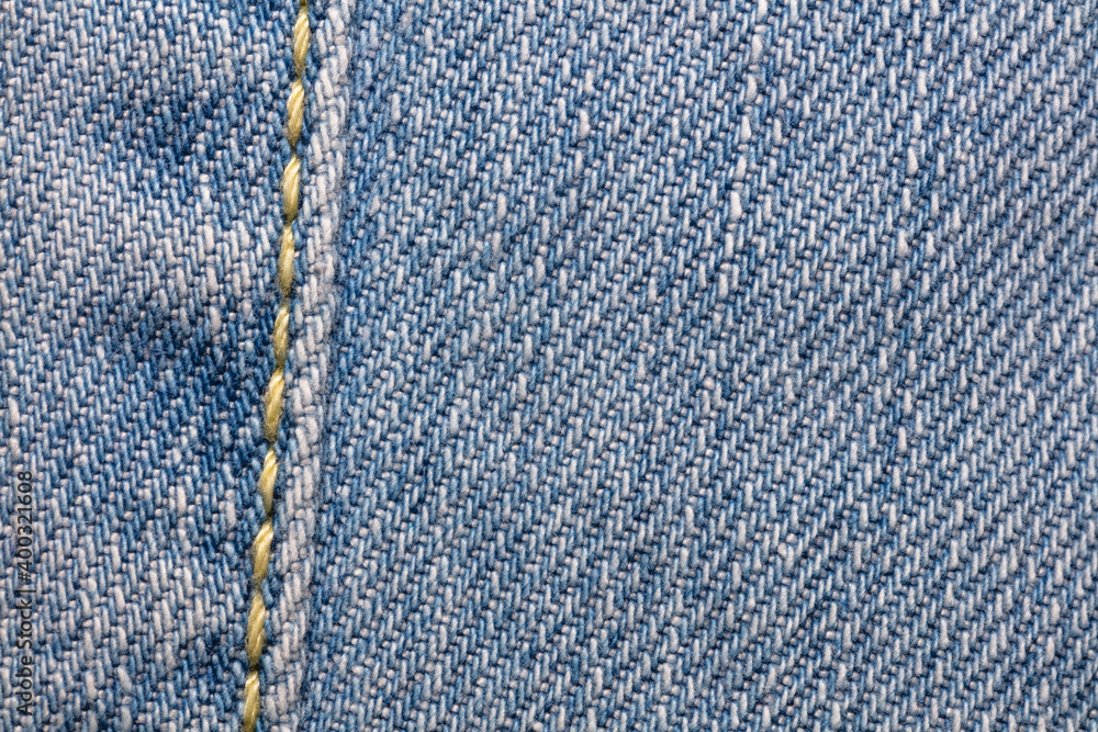 Close-up shot of blue jeans fabric with a seam. Copy space. Top view. Clothing store and shopping concept Close-up shot of blue jeans fabric with a seam. Copy space. Top view. Clothing store and shopping concept