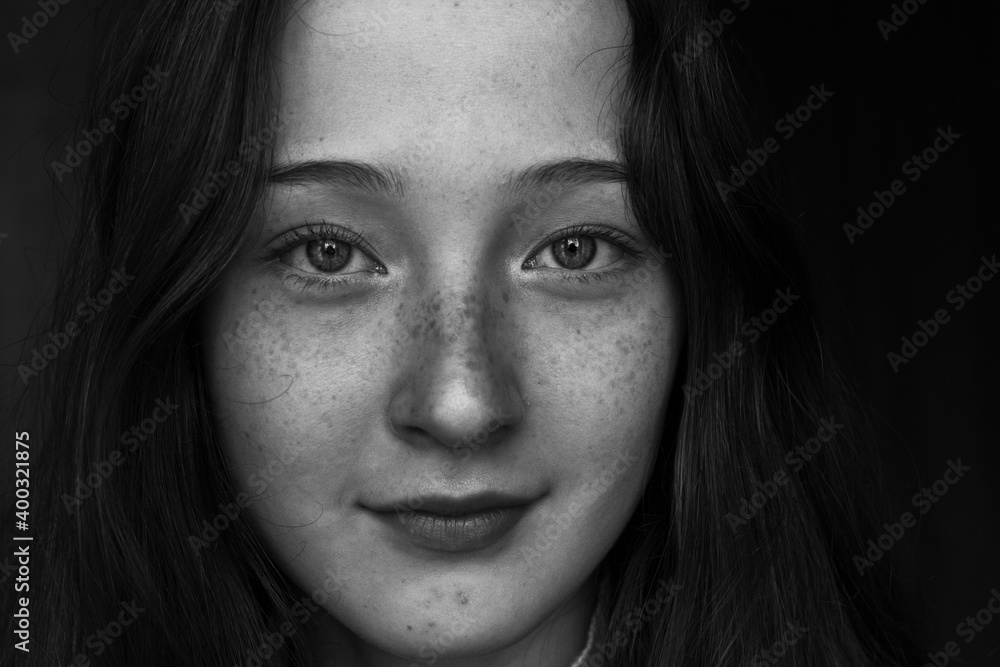 close up portrait of a young woman with freckles close up portrait of a young woman with freckles