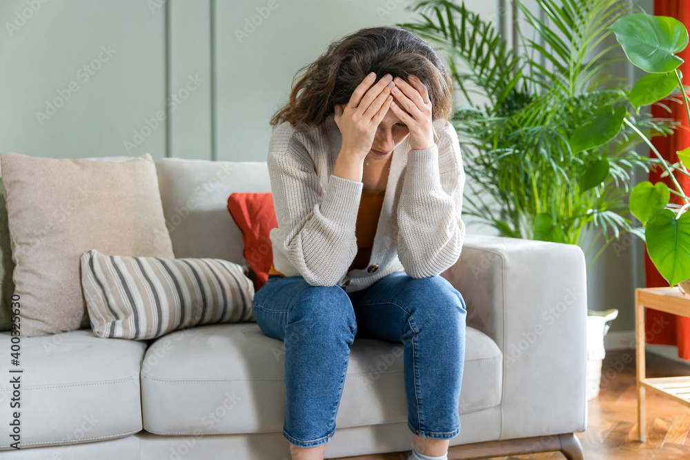 Depressed young woman on sofa at home. Depressed young woman on sofa at home.