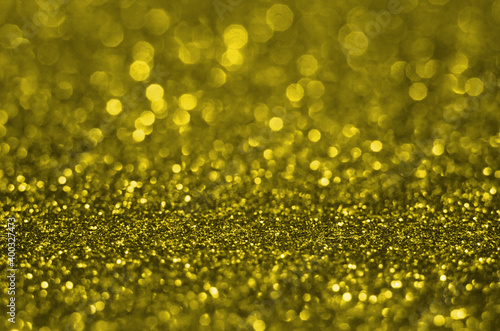 Illuminating Pantone Color Of The Year 2021. Abstract festive bokeh background with shining defocus sparkles. Blurred glitters shimmering dust macro close up, copy space for text logo