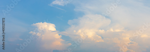 Panorama or panoramic photo of blue sky and white clouds or cloudscape at sunset or evening time. for breathing concepts background.