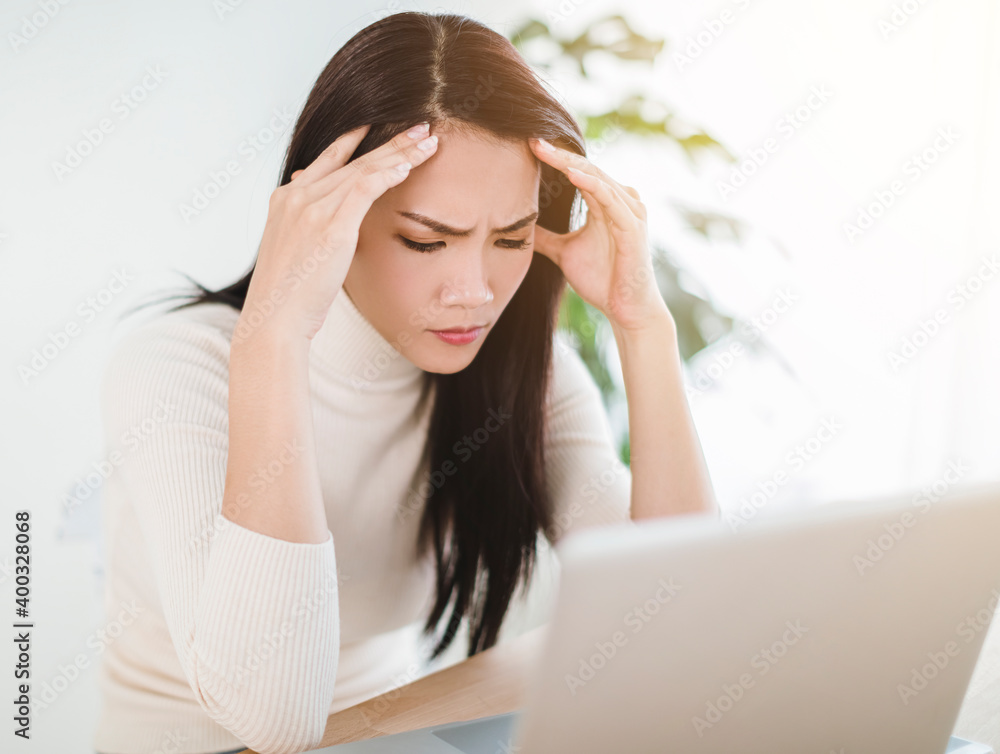 stressed woman feeling tired and worry about work problem looking at laptop stressed woman feeling tired and worry about work problem looking at laptop