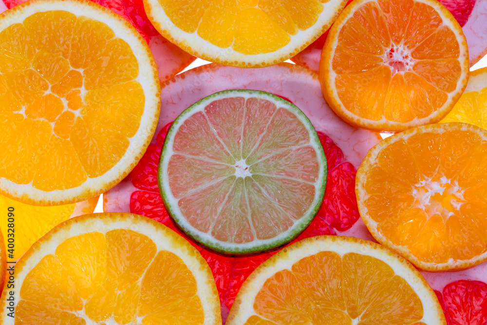 Background of fruit slices of red grapefruit, green lime and mandarin, close up Background of fruit slices of red grapefruit, green lime and mandarin, close up