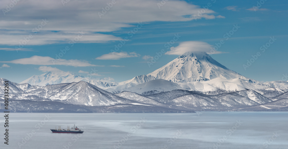 Kamchatka, frosty morning in the water area of Avacha Bay, Vilyuchinsky volcano in the background.