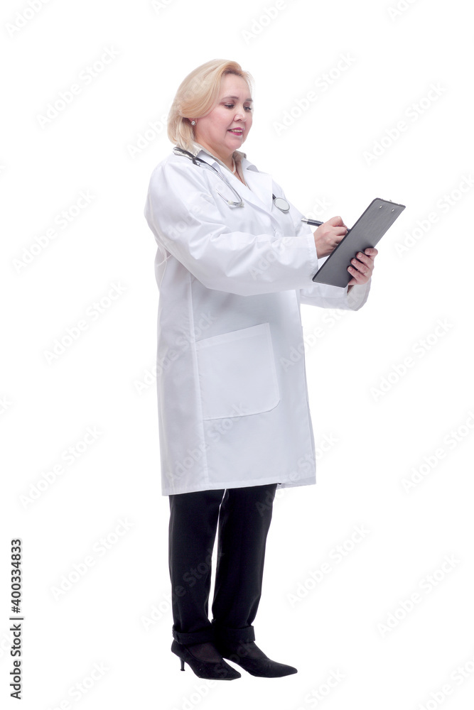Profile of a pretty doctor with white lab coat, stethoscope smiling and writing notes in clipboard Profile of a pretty doctor with white lab coat, stethoscope smiling and writing notes in clipboard
