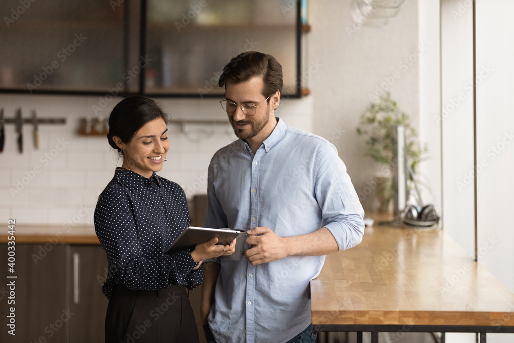 Stockfoto Happy diverse employees look at tablet screen brainstorm ...