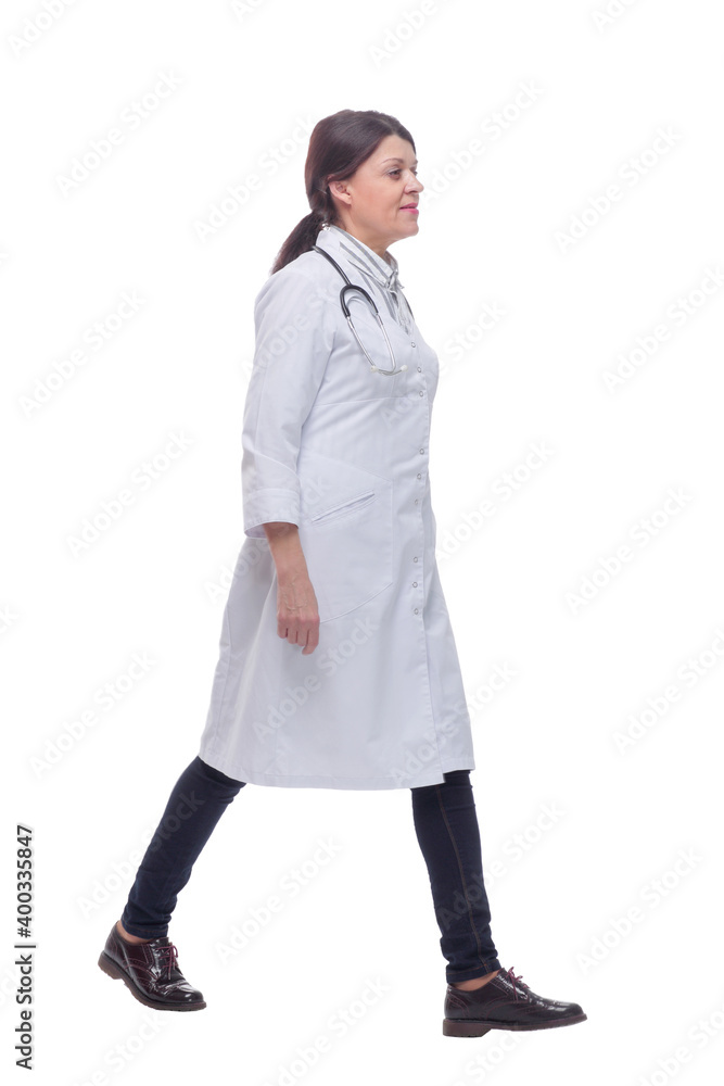 Full length portrait of female doctor walking towards the camera smiling Full length portrait of female doctor walking towards the camera smiling