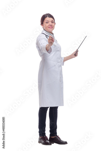 Full length side view of caucasian female doctor is writing on a clipboard