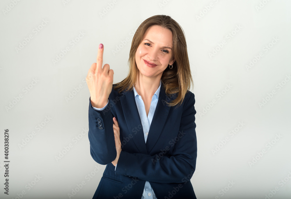 Young business lady shows fuck off sign isolated on grey background