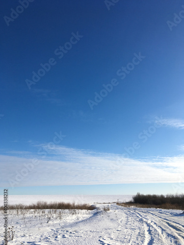 Endless winter landscape on a sunny day with blue sky
