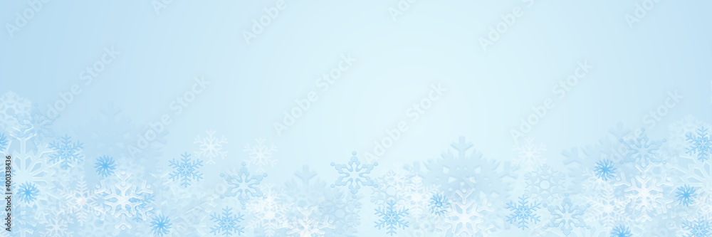 Pastel blue winter background with snowflakes, copy space