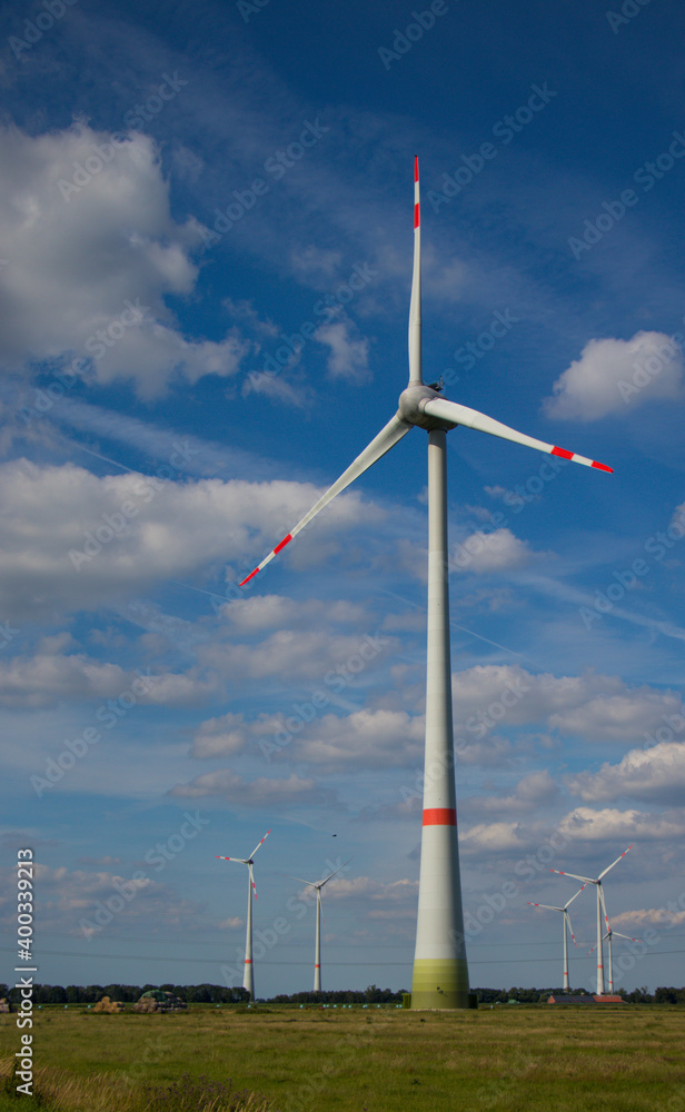 wind turbine in the wind before blue cloudy sky wind turbine in the wind before blue cloudy sky