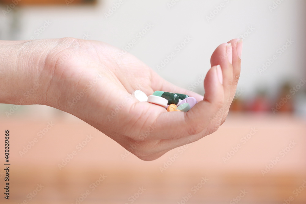Clouse-up woman with holding pills on on hand. Clouse-up woman with holding pills on on hand.