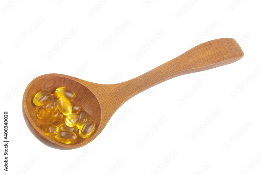 Omega 3 capsules in wooden spoon isolated on white background Omega 3 capsules in wooden spoon isolated on white background