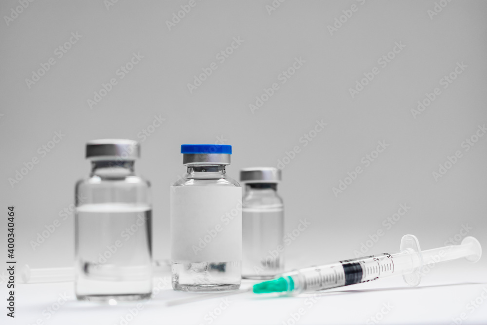 Medical treatment syringes and vaccine bottles in white environment Medical treatment syringes and vaccine bottles in white environment