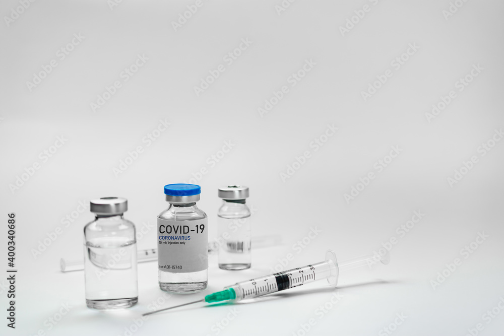 Covid19 Vaccine syringes and medicine bottles in white environment Covid19 Vaccine syringes and medicine bottles in white environment