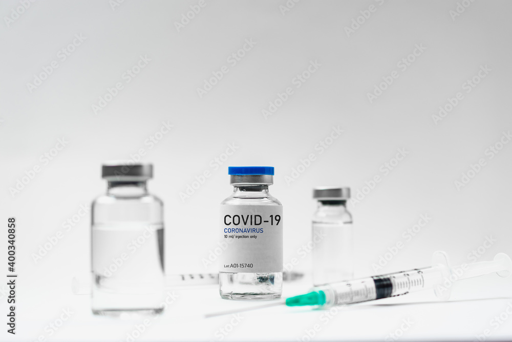 Covid19 Vaccine syringes and medicine bottles in white environment Covid19 Vaccine syringes and medicine bottles in white environment
