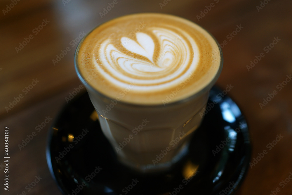 Coffee to go. Fresh latte in a cup on a wooden table in a cafe. Coffee to go. Fresh latte in a cup on a wooden table in a cafe.