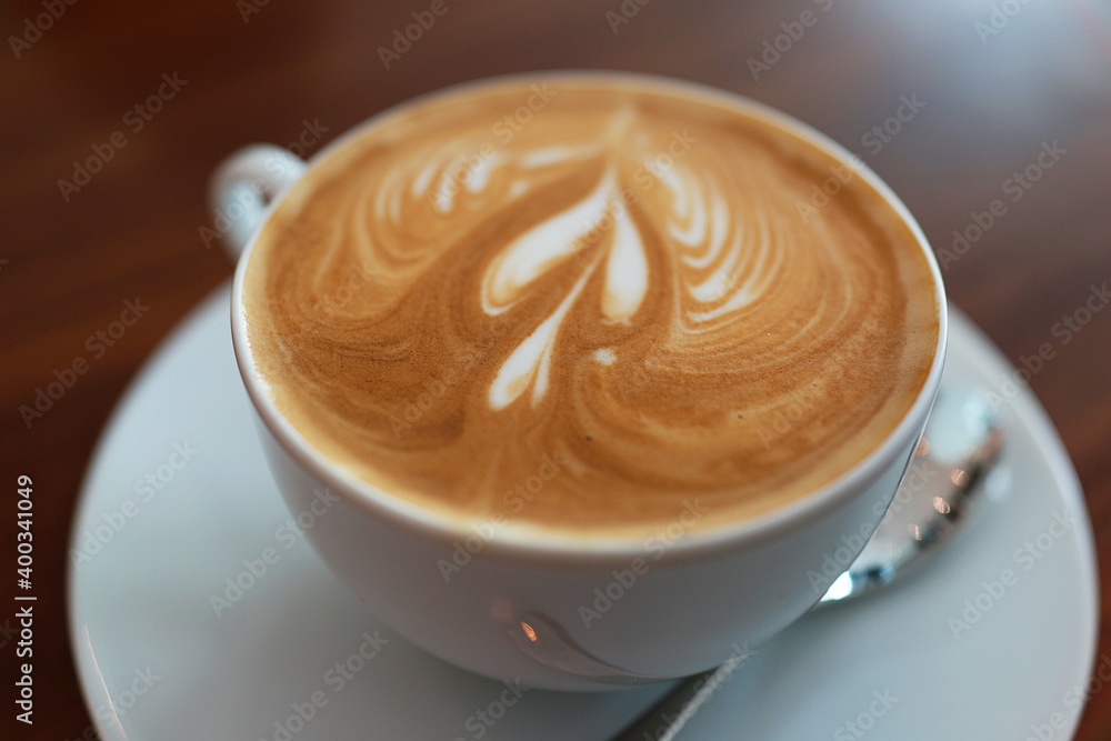 Coffee to go. Fresh latte in a cup on a wooden table in a cafe. Coffee to go. Fresh latte in a cup on a wooden table in a cafe.