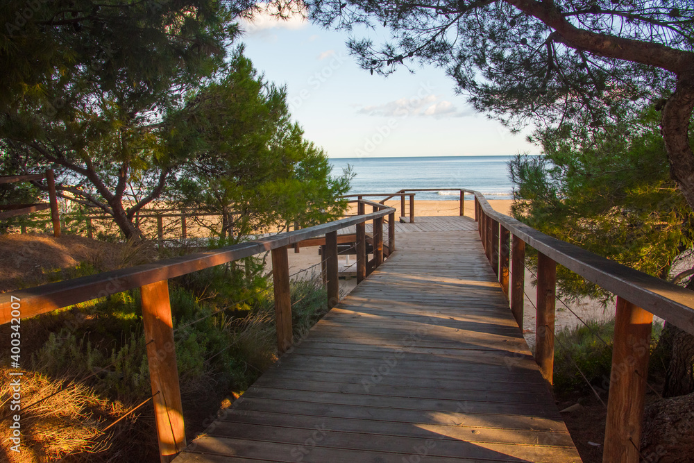 Wooden structure leading to the beach. Beautiful promenade near the shore.