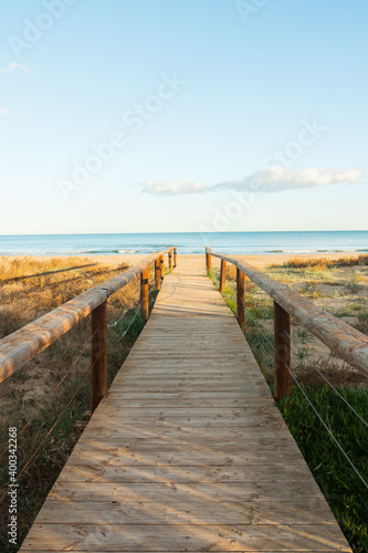 Fototapeta Naklejka Na Ścianę i Meble -  Beautiful wooden boardwalk leading to the beach.