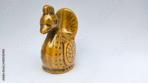 brown statue of swan in a white isolated background