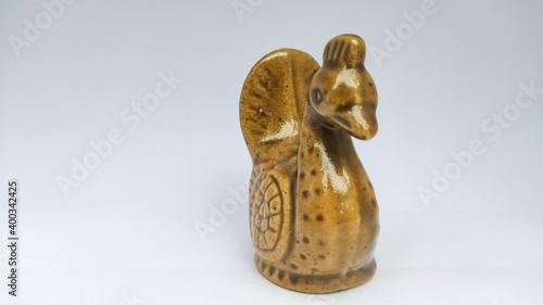 brown statue of swan in a white isolated background