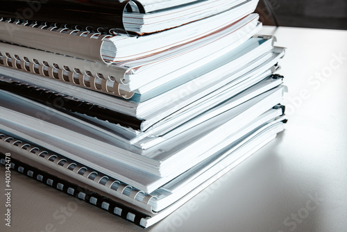 Fotografering Stack of reports lies on a desk ready for review