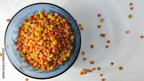 split chickpeas in glass bowl on a white isolated surface