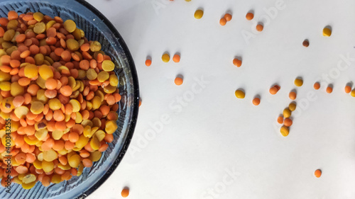 split chickpeas in glass bowl on a white isolated surface