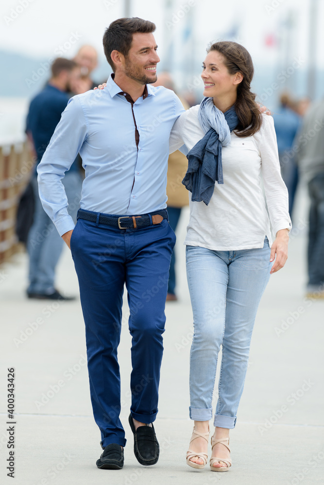 man and woman walking on a pier